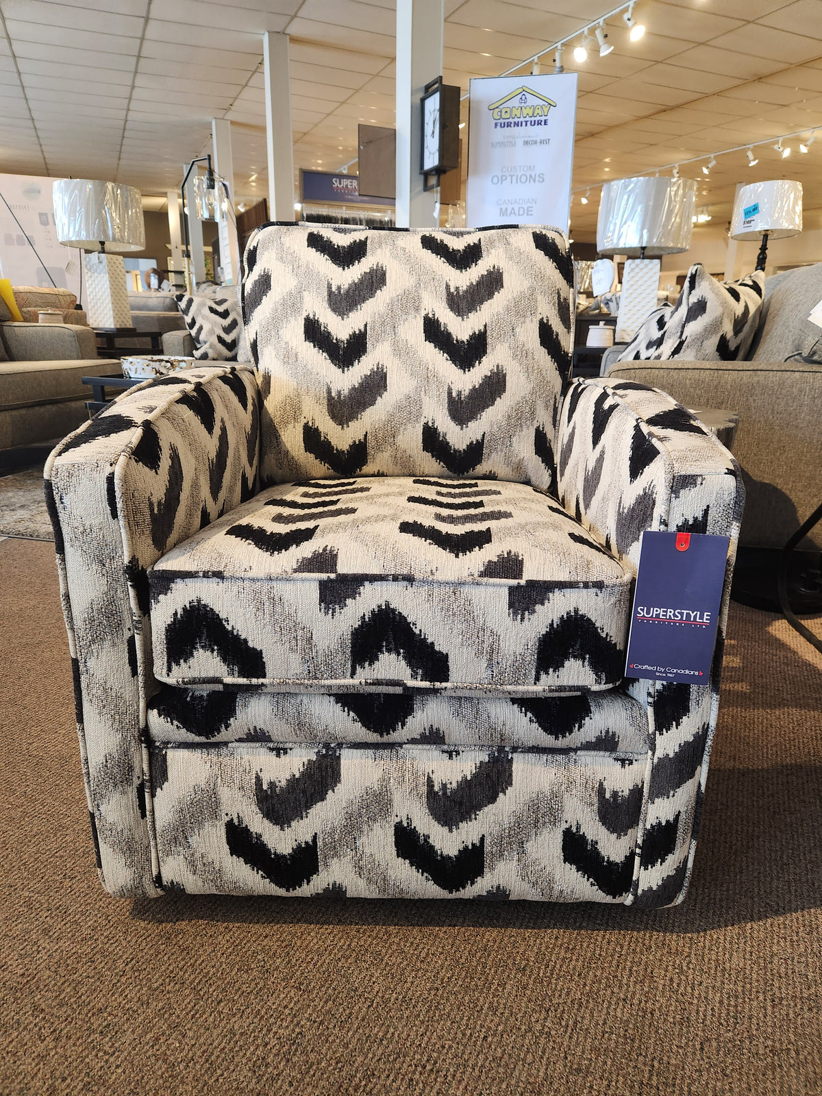 Superstyle 37-59C Swivel Chair with black/gray chevron pattern, displayed on a carpeted showroom floor.