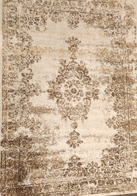 Kalora's Faira Area Rug: Beige-brown with a bohemian, distressed floral pattern.