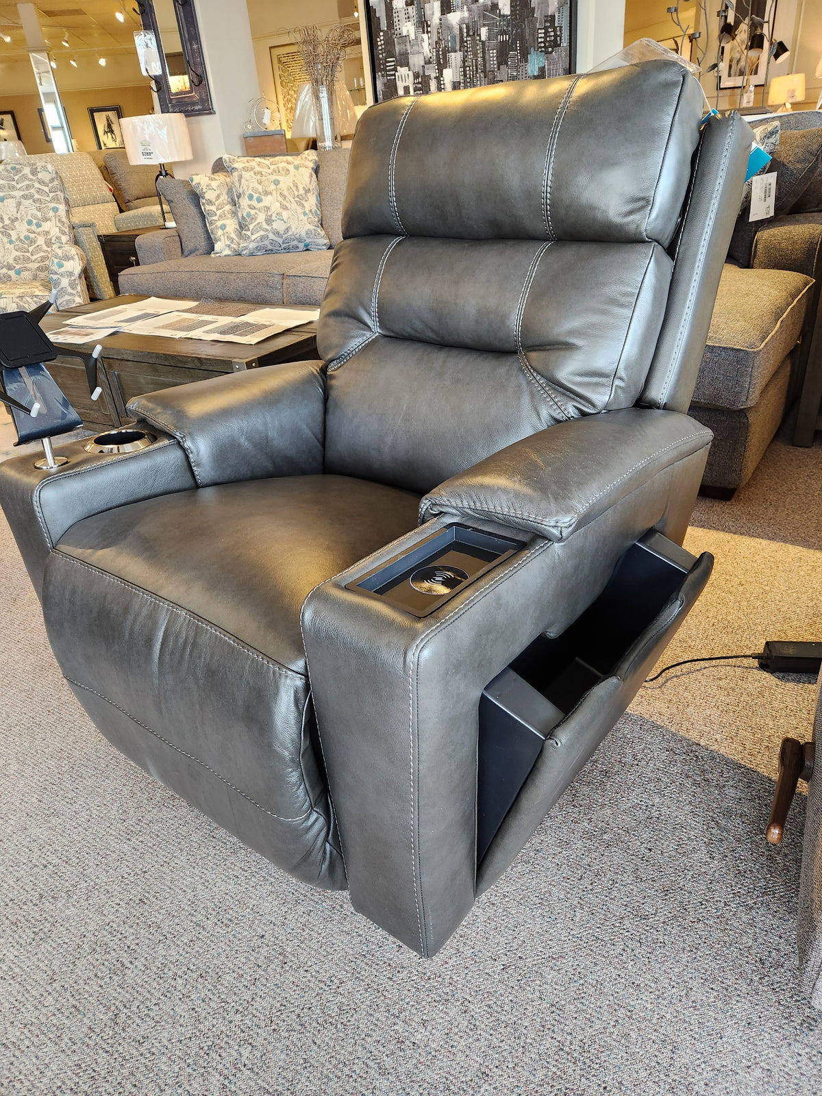 A gray La-z-boy 762-10X Neo Power Rocker Recliner with cup holders, storage, and adjustable headrest in a showroom.