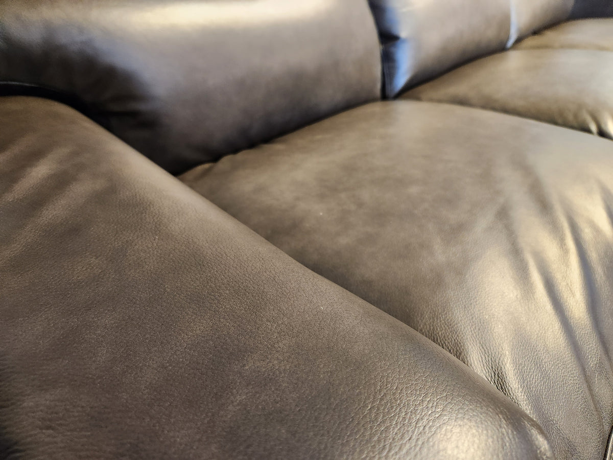 Close-up of a black leather Lay-Z-Boy Ava 769-U44 Sofa by La-z-boy, highlighting its smooth texture and cushioned surface, epitomizing elegant furniture with a tailored design.