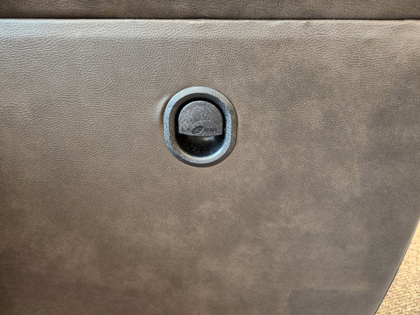 Close-up of a black circular latch on the La-z-boy Ava Loveseat's textured dark gray surface.