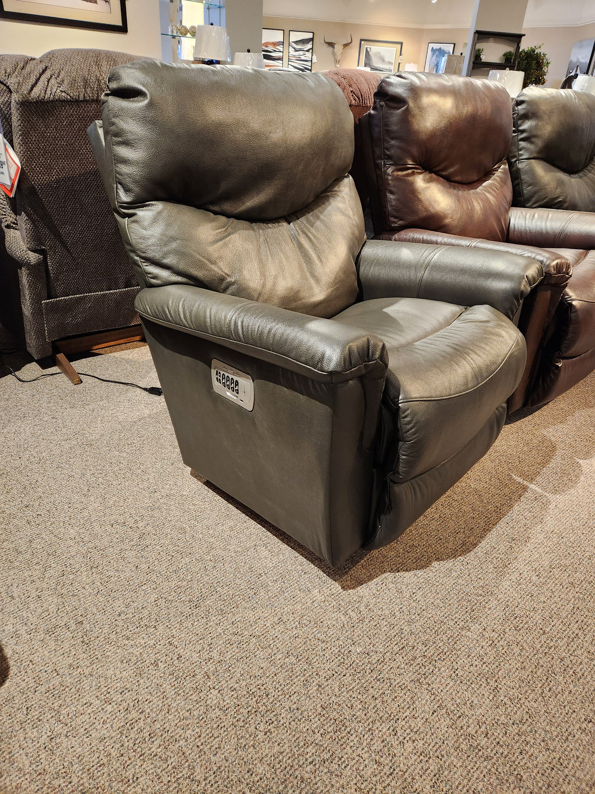 A La-Z-Boy 521 James Power Leather Rocker Recliner in green, between a brown recliner and a gray fabric chair.