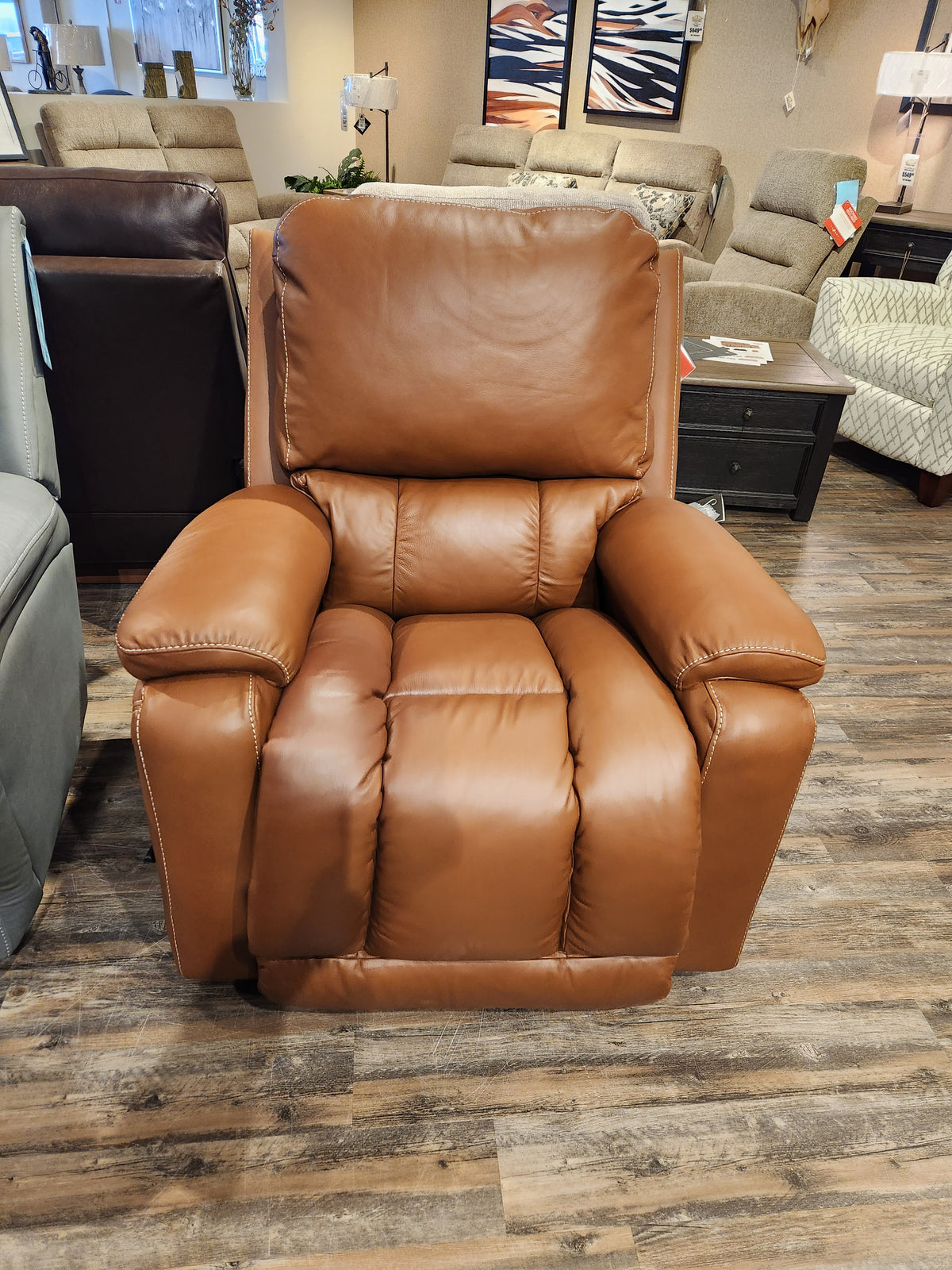 The La-Z-Boy 530 Greyson Rocker Recliner in brown leather with power recline is showcased on wooden flooring.