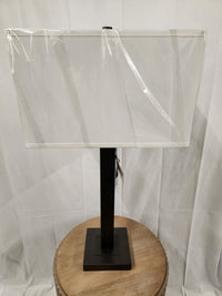 Cooper Table Lamp by Pacific Coast: Gunmetal finish, round wooden base, rectangular black stand, and shade.