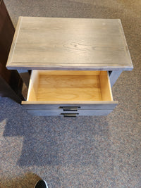 The 740 Bungalow nightstand by Vaughan Bassett has a charming design, featuring an open drawer on a carpeted floor.