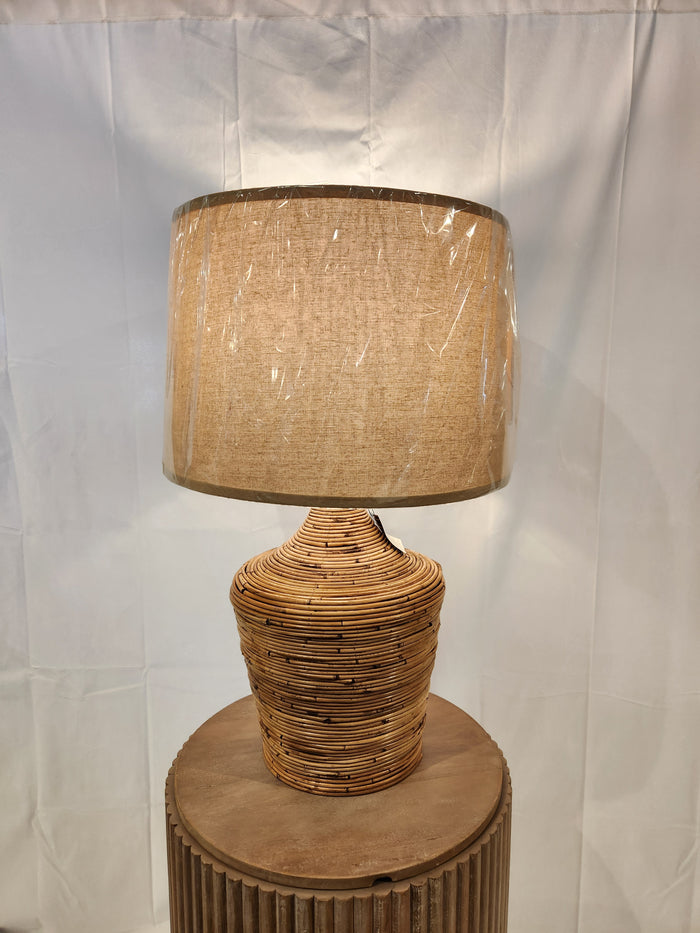 The L329034 Kerrus Table Lamp by Ashley has a natural rattan and beige shade, perfect for coastal cottage decor.