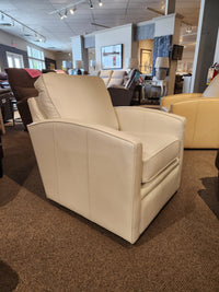 The Superstyle 37-59C Swivel Chair, crafted from white leather and providing comfortable support, is elegantly showcased in a showroom among other furniture pieces. Its design seamlessly combines traditional aesthetics with the sleek functionality of a modern office chair.