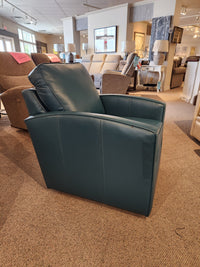 A teal leather 37-59C Swivel Chair by Superstyle, crafted for comfortable support, is showcased in a furniture store showroom alongside various other chairs.