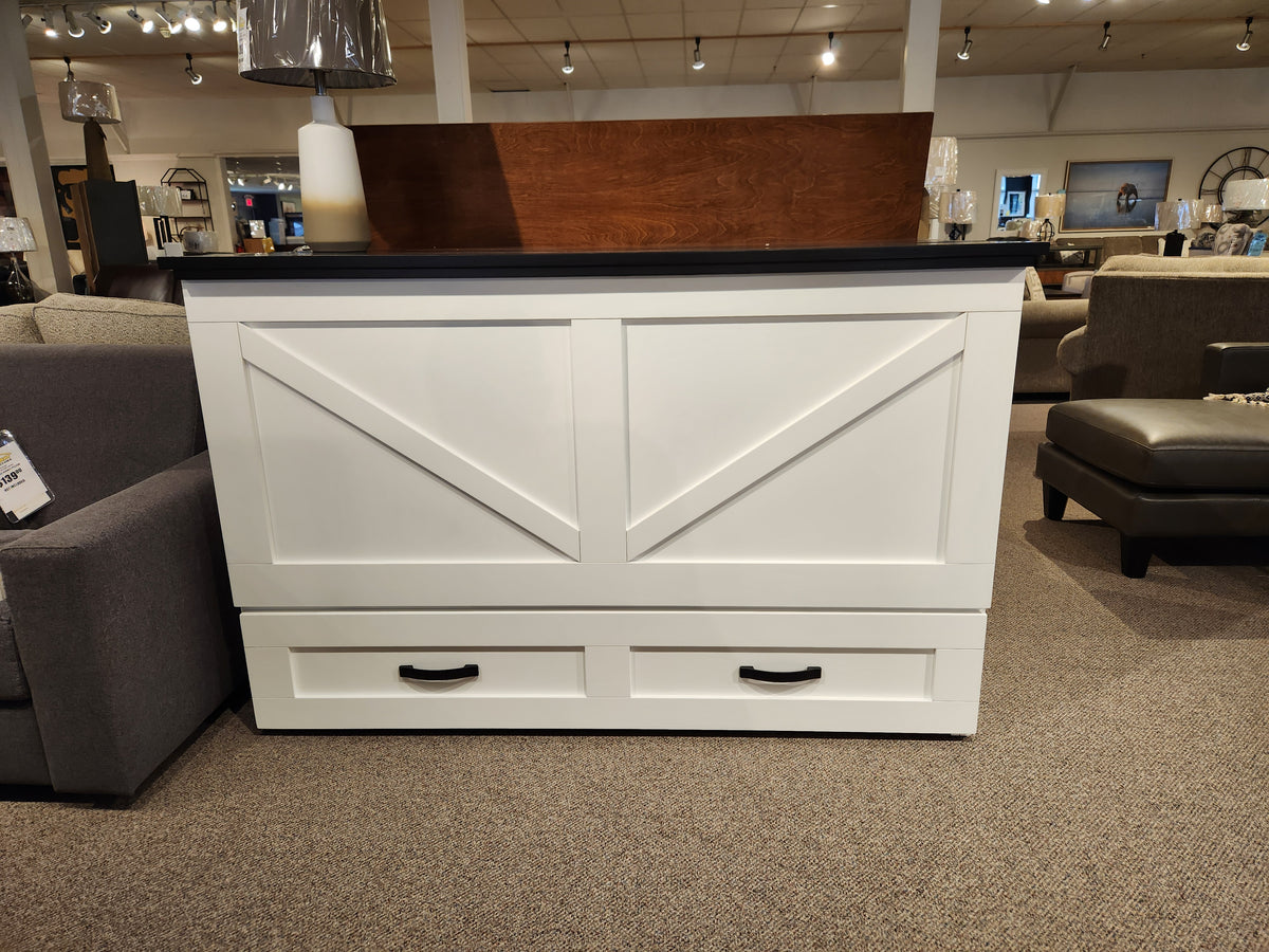 A Barn Black Elite Series cabinet bed by Cabinet Bed Inc with white wood, black handles, and a dark countertop in a showroom.