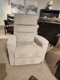 The 786 Liam Rocker Recliner by La-Z-Boy, celebrated for its casual style and comfort, is displayed with sophistication in a showroom. It is positioned between two paintings and surrounded by other furniture pieces, providing a sense of ultimate relaxation.