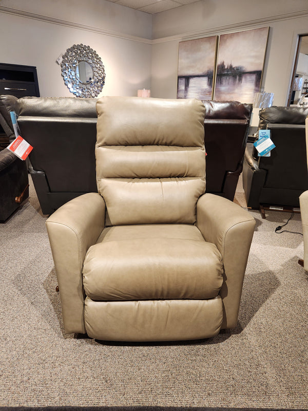 The 786 Liam Rocker Recliner by La-z-boy, elegantly crafted from beige leather, exudes comfort as it becomes the focal point of the showroom. Positioned among other casually styled chairs, it promises to elevate relaxation to an entirely new level.