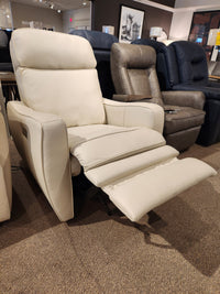 The Oakridge 40180-C1 Power Chair by Palliser, displayed in the furniture showroom, features durable spring seats and an extended footrest, providing both comfort and a touch of luxury.