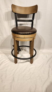 The Ashley D542 Pinnadel pub height bar stool features a faux leather seat and circular footrest on a white background.