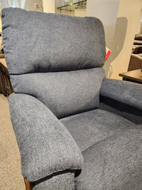 The 727 Brooks Rocker Recliner by La-z-boy features a modern silhouette, with its cozy blue-gray upholstery making it a standout piece in the showroom.