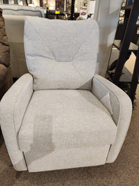 Palliser 42002 Theo swivel rocker recliner in light gray with padded armrests & recline options on a carpeted showroom floor.