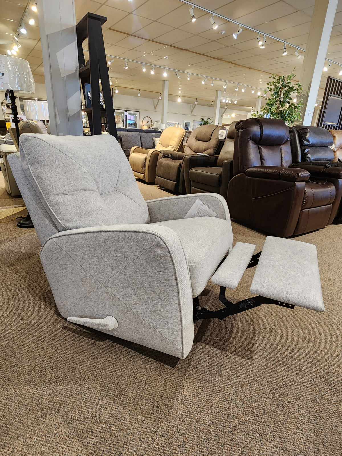 Palliser's 42002 Theo Swivel Rocker Recliner in gray features customizable recline options in the showroom.