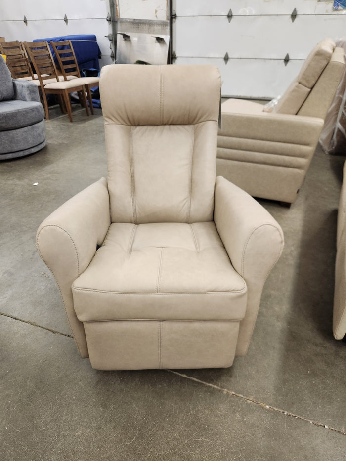 A 42201 Yellowstone I Rocker Recliner in beige from Palliser is displayed in a showroom, surrounded by other furniture pieces in the background, exemplifying ergonomic comfort.