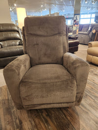 Experience relaxation with the La-z-boy 715 Kodie Rocker Recliner, featuring luxurious brown corduroy fabric, beautifully displayed on the wooden floor of a furniture store showroom.