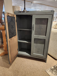 Introducing the 357 Punched Tin Cupboard by Woodcraft, an Amish-made piece crafted from rustic wood. The cupboard boasts one open door that reveals spacious shelves for ample storage and beautifully showcases its star-patterned punched tin panels.