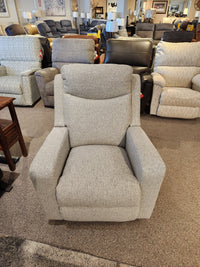 A La-Z-Boy Emmons Rocker Recliner in gray fabric is displayed in a showroom with other recliners and chairs.