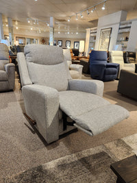 La-z-boy 781 Emmons Rocker Recliner with extended footrest in showroom; other chairs and decor visible.