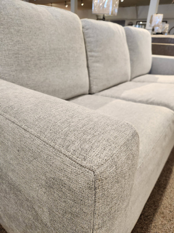 Close-up of Palliser 40526-22 Kildonan Queen Sofa Bed in gray with plush cushions and memory foam in a showroom.