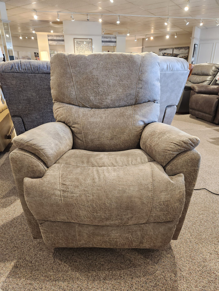 The La-Z-Boy 724 Trouper Power Rocker Recliner in beige has lumbar support and is showcased with stylish furniture.