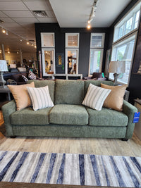 Superstyle's Canadian-made 7002 Sofa in designer fabric with 4 cushions on light wood floor and striped rug.