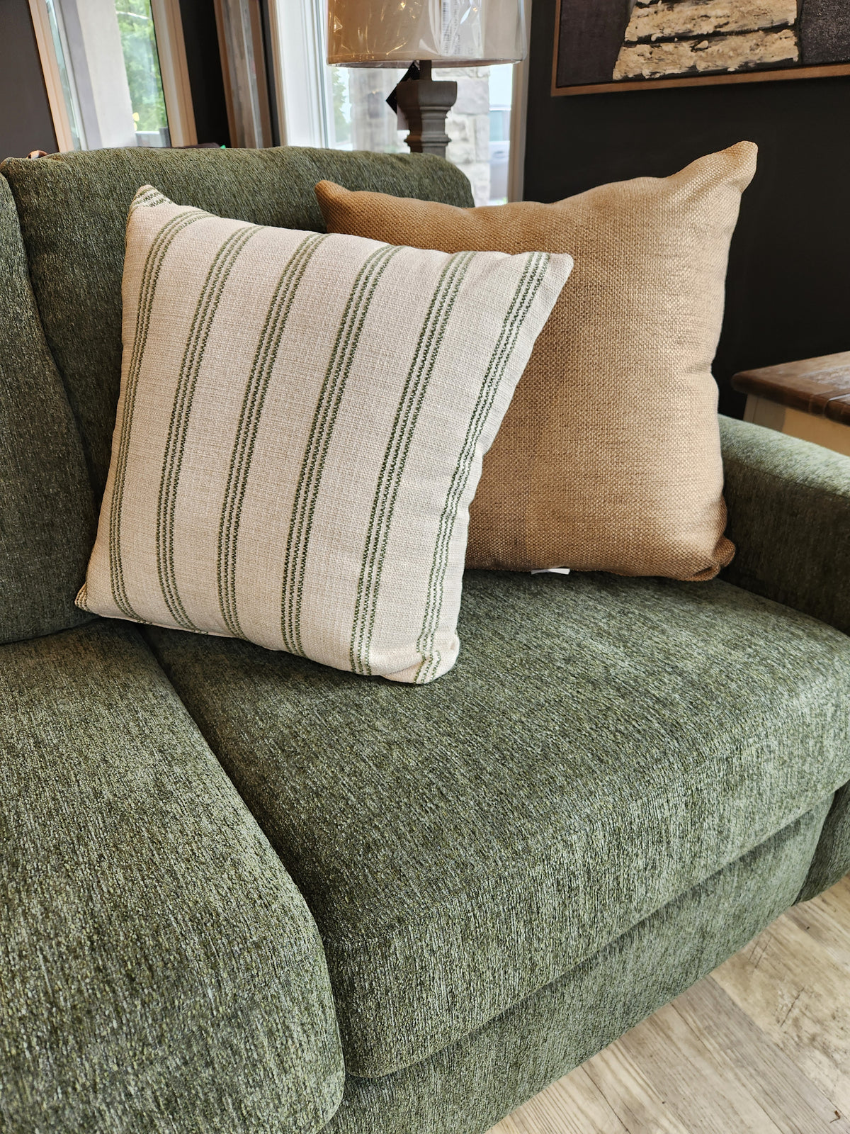 Two pillows, striped and solid, in designer fabric on a Superstyle 7002 Sofa by large windows with custom upholstery.