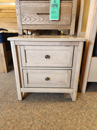 The Vaughan Bassett 821 Woodbridge nightstand, solid Ambrosia Maple, has a price tag on the top drawer's french dovetail handle.