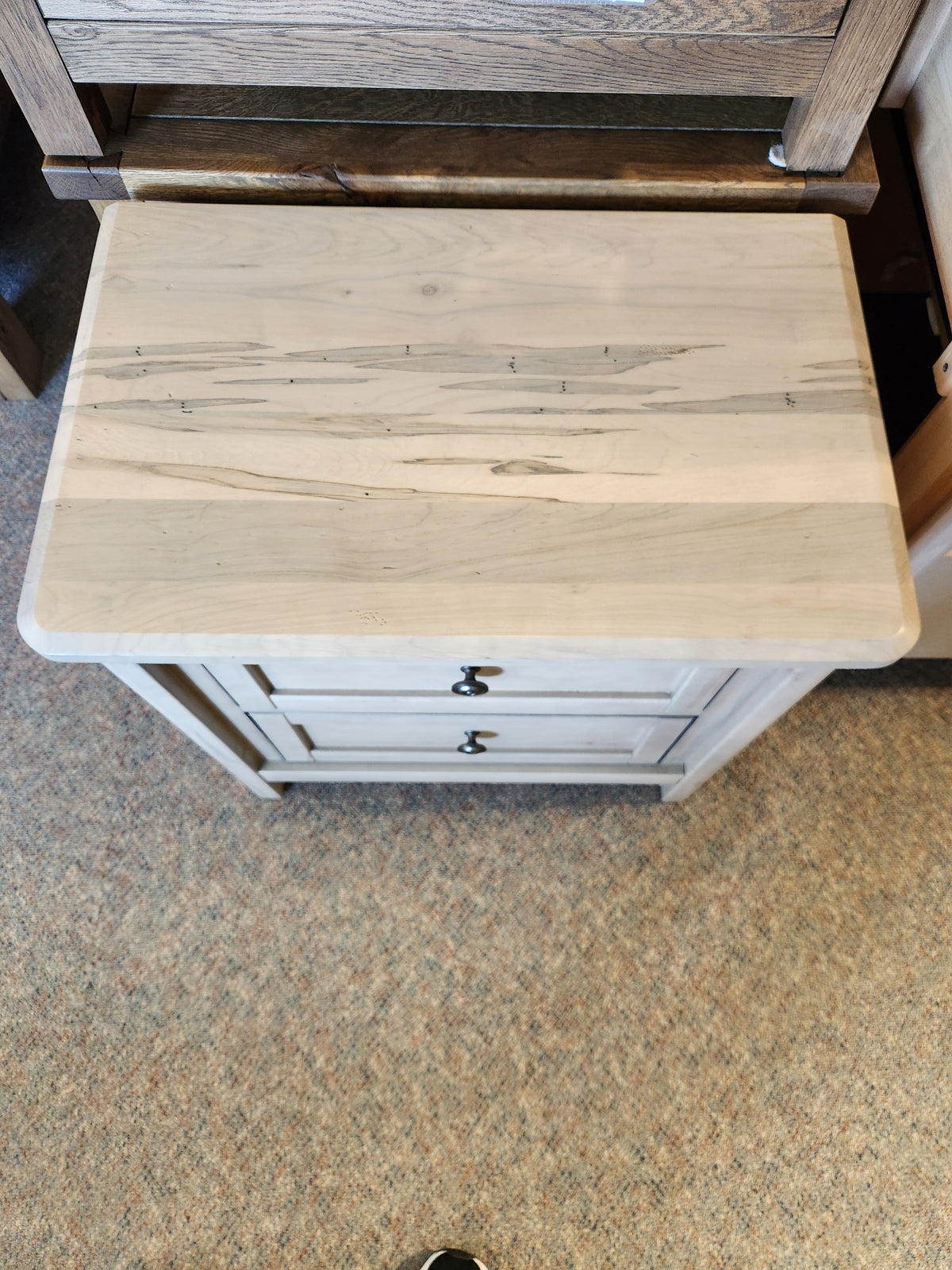 The Vaughan Bassett 821 Woodbridge Nightstand features French dovetail drawers in American Ambrosia Maple on carpet.