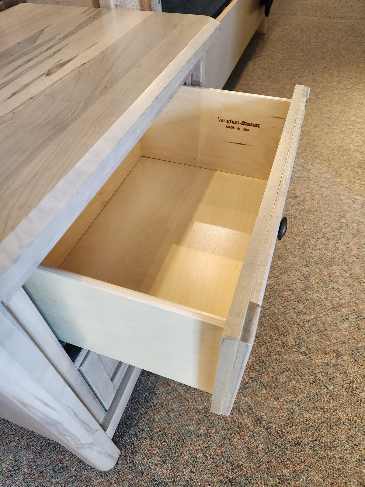 Vaughan Bassett's 821 Woodbridge Nightstand drawer ajar, displaying its empty French dovetail Ambrosia Maple interior.