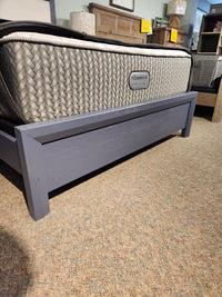 The Vaughan Bassett 126 Artisan & Post Queen Bed with performance fabric is elegantly displayed in the showroom.