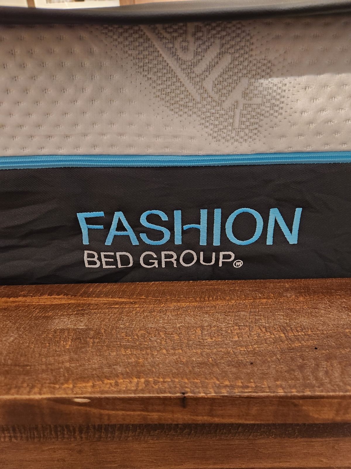 Label on the Bella Vita Plush 12" Split Mattress reads "Fashion" in blue and white, set against a brown backdrop. Adjustable base.