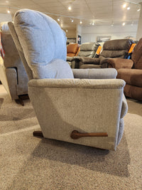 A side view of the light gray La-Z-Boy 795 Mercury Rocker Recliner in a showroom, surrounded by other recliners.