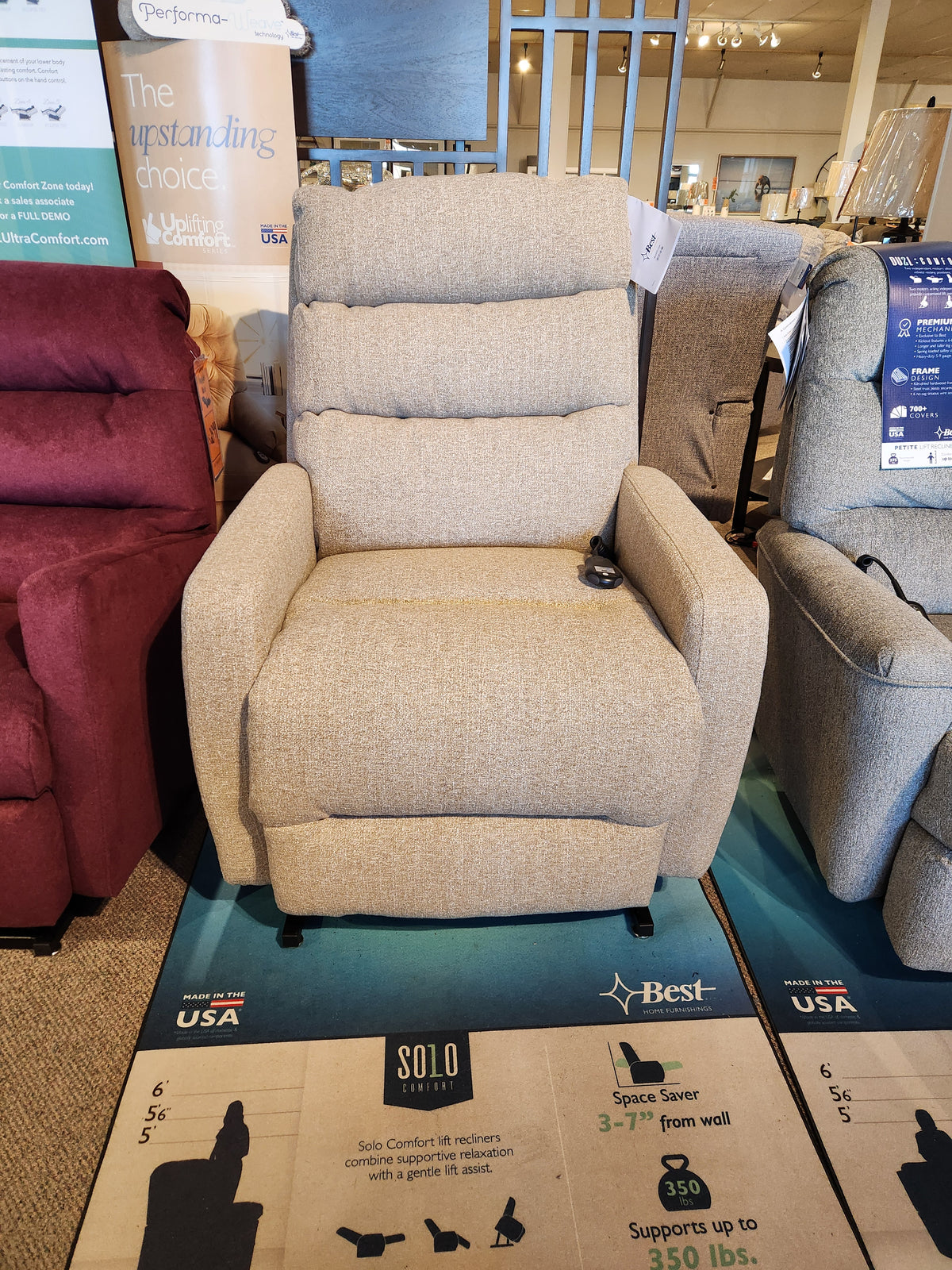 The 9NZ31 Kristisha Power Lift Chair by Best in beige, with comfort positions and Tilt Headrest, is displayed in the store.