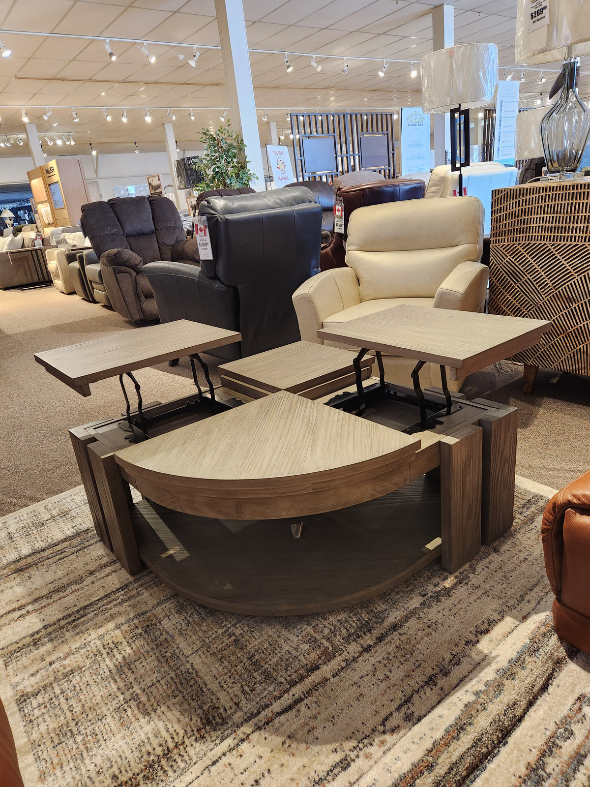 Magnussen showroom with rustic charm features the T5865 Conrad Pie Shaped Lift Top Cocktail Table among various chairs and sofas.