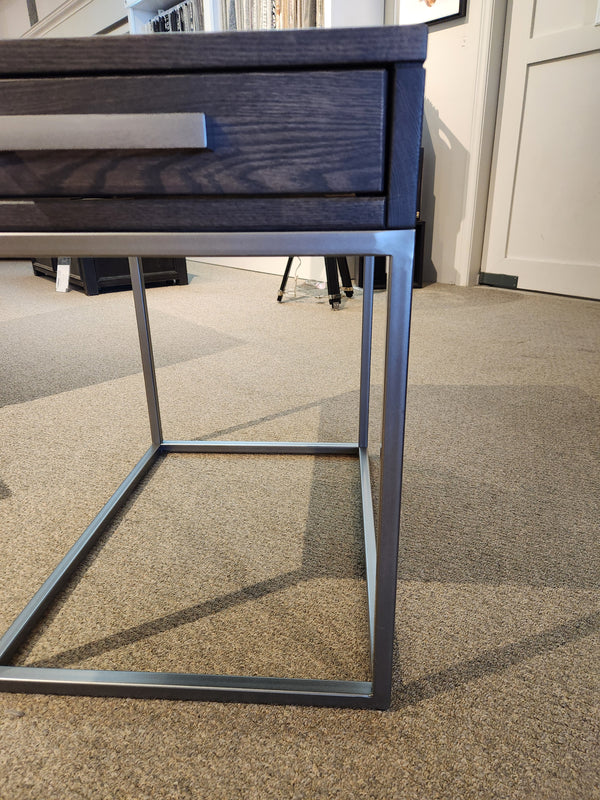 Handstone's Muskoka 24" End Table with a metal frame and solid oak top sits elegantly on a beige carpeted floor.