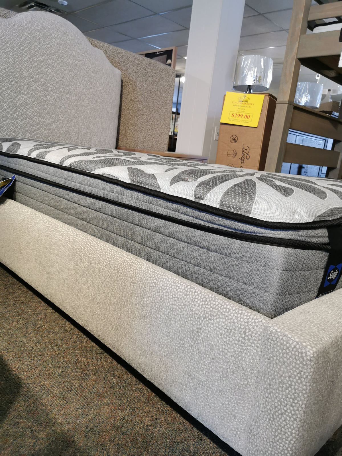 The Vaughan Bassett Upholstered Tide & Timber Twin Bed has a yellow sale sign with a $2,280.00 price in store.