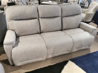 Best's S650RZ4 Derek Power Sofa in gray, displayed with a geometric black/white pattern carpet.