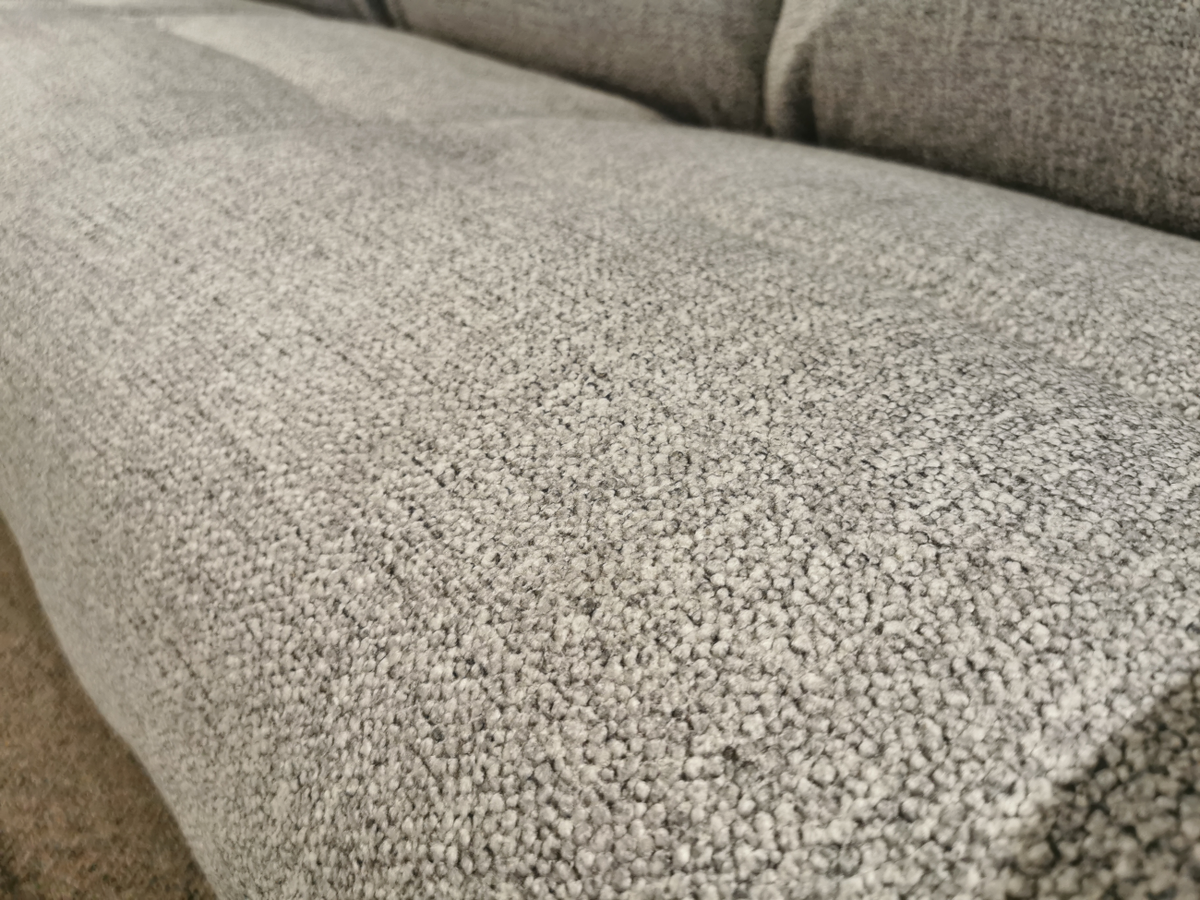 Close-up of the 706 Jay Power with Head-Rest Sofa by La-Z-Boy, highlighting its gray fabric with visible texture and stitching. The upholstery details and reclining comfort invite you to relax.