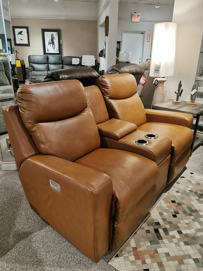 Experience ultimate comfort in a showroom setting with the La-Z-Boy 781 Emmons Power Reclining Loveseat, featuring a tan leather finish, plush backs, convenient cup holders, and a center console.