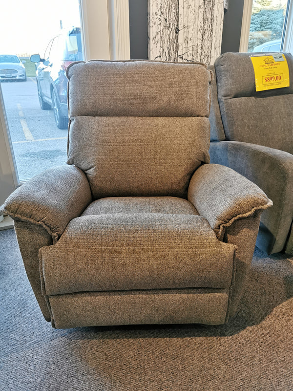 The La-z-boy 706 Jay Power Rocker Recliner, a favorite among families, is elegantly showcased in the store with its gray upholstery and casual style. A price tag hangs invitingly, encouraging you to experience unmatched comfort in your home.