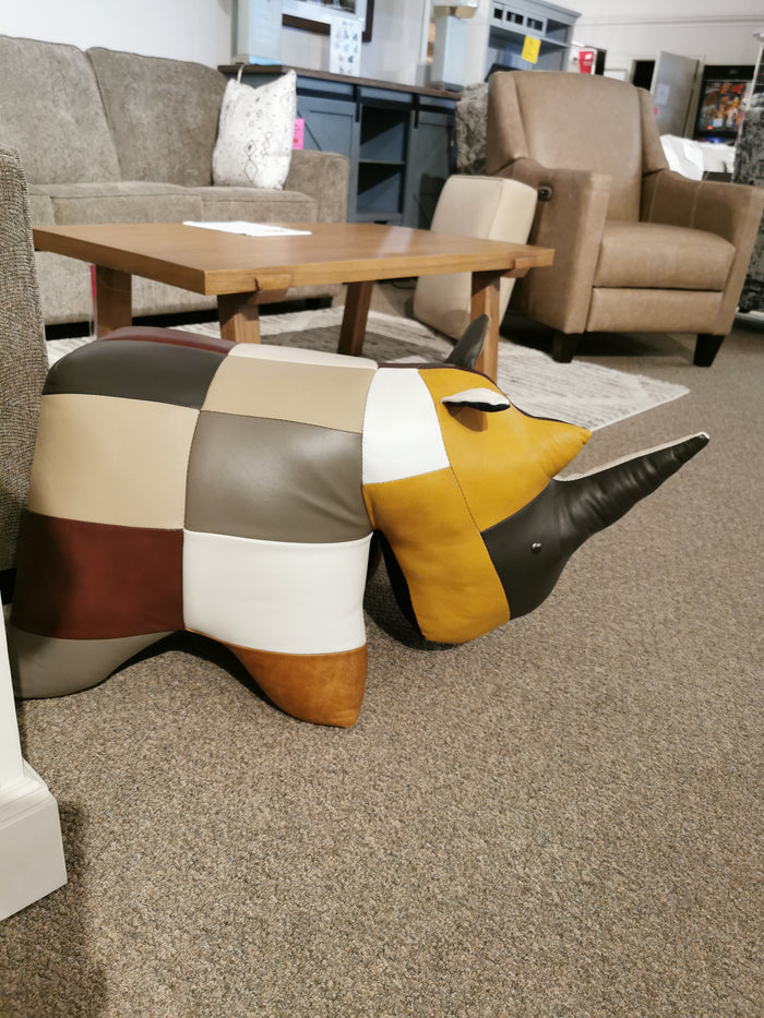 Reiner's Originals' Reiner's Leather Animal Ottomans-- Rhino is displayed on a carpeted showroom floor.