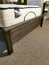 11 Fundamental Panel Double Bed by Vaughan Bassett with mattress on carpet, showcased in a bedroom furniture showroom.