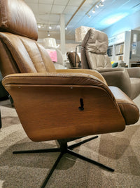 The furniture store showroom is graced by the Vilma Recliner with Ottoman from Donald Choi, a luxurious chair with a swivel base, upholstered in fine Italian leather.