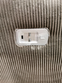 Close-up of a USB and power outlet panel on the textured, ribbed fabric surface of the La-Z-Boy 761 Joel Power Reclining Loveseat with cushioned arm pads.