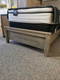 The Vaughan Bassett Fundamental Panel Twin Bed is elegantly displayed among the finest bedroom furniture in the store showroom.