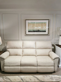 A beige La-Z-Boy 727 Brooks Reclining Sofa sits against a wall, framed art above, adding reclining comfort to the living room.