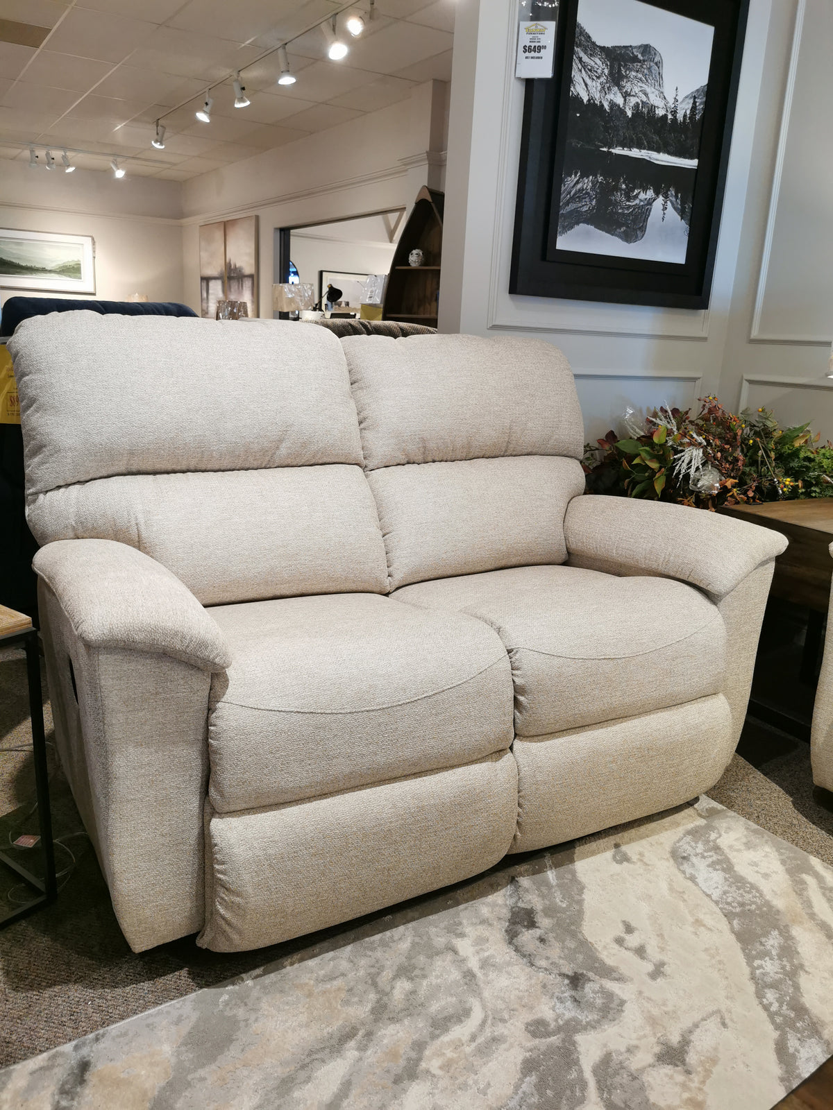 Experience personalized comfort with the La-z-boy 727 Brooks Reclining Loveseat, paired with framed art and a rug.